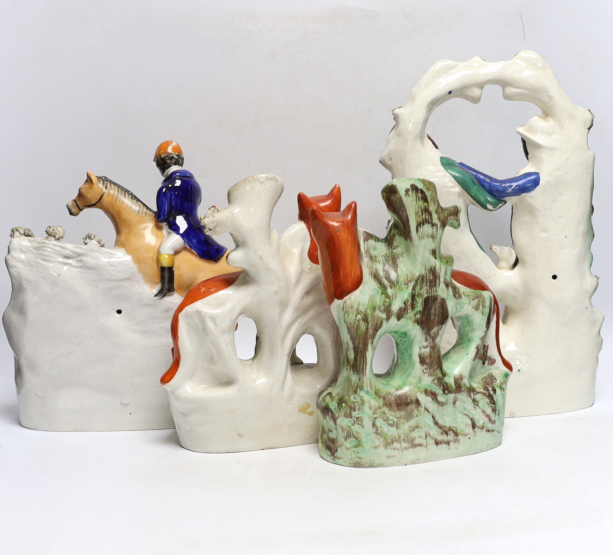 Two mid 19th century Staffordshire hunting figure groups and a pair of fox spill vases, 33cm